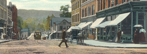 a man walking across main street