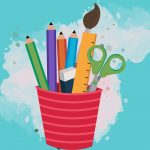 A red cup with colored pencils and other craft tools.