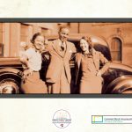 An historic photo of a car and three people.