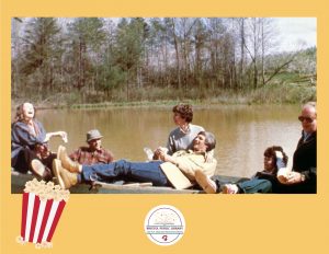 Three middle-aged couples on a boat on a pond.